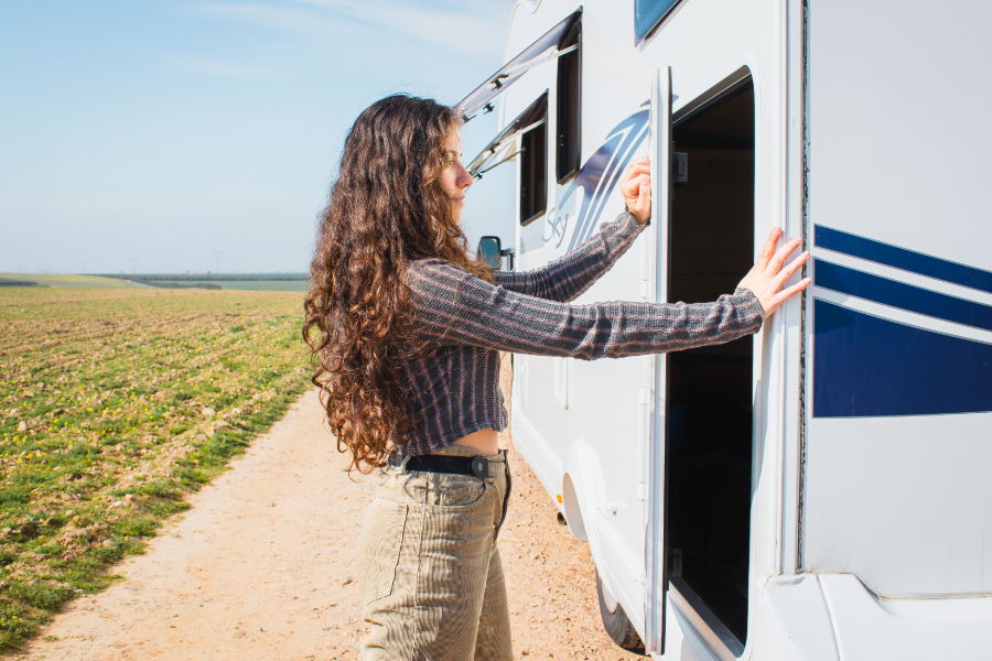 woman looking at storage compartment in rv